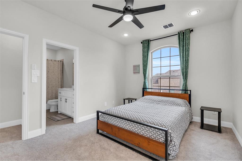 3511 Solaro Lane Rockwall, TX 75087 - Photo 31 of 40 a bedroom with a bed and a window