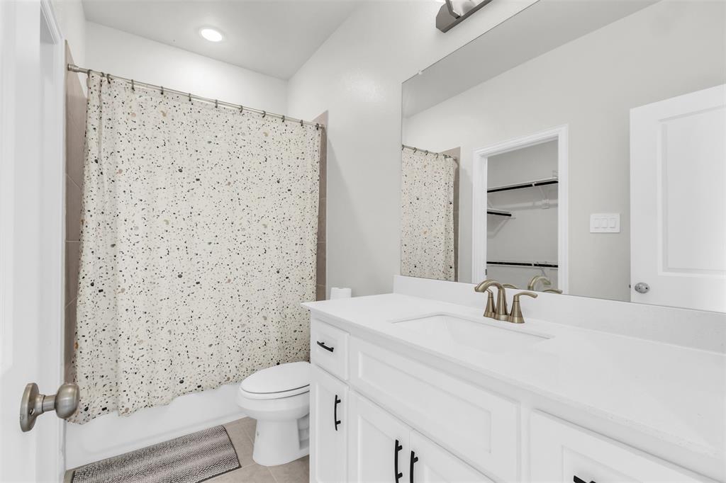 3511 Solaro Lane Rockwall, TX 75087 - Photo 32 of 40 a bathroom with a sink a toilet and shower