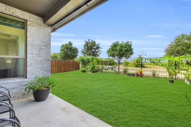 a view of a garden with plants and a bench
