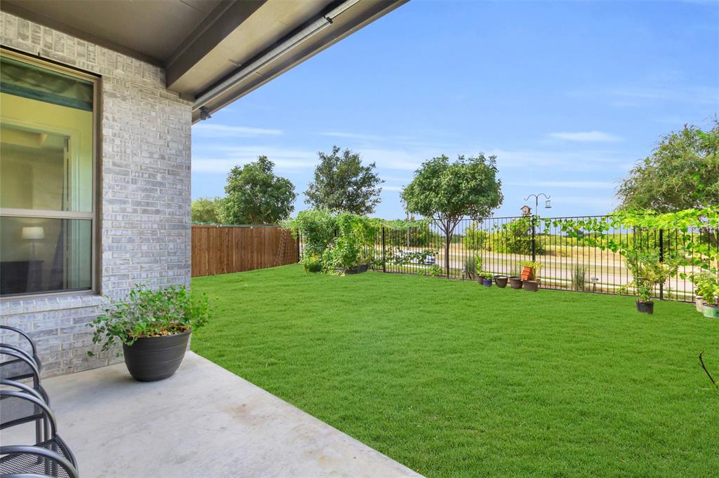 3511 Solaro Lane Rockwall, TX 75087 - Photo 34 of 40 a view of a garden with plants and a bench