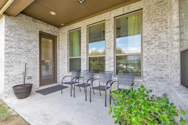 a view of a patio with table and chairs and potted plants