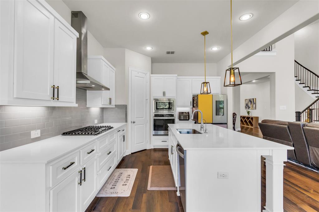3511 Solaro Lane Rockwall, TX 75087 - Photo 8 of 40 a kitchen that has a lot of cabinets in it and appliances
