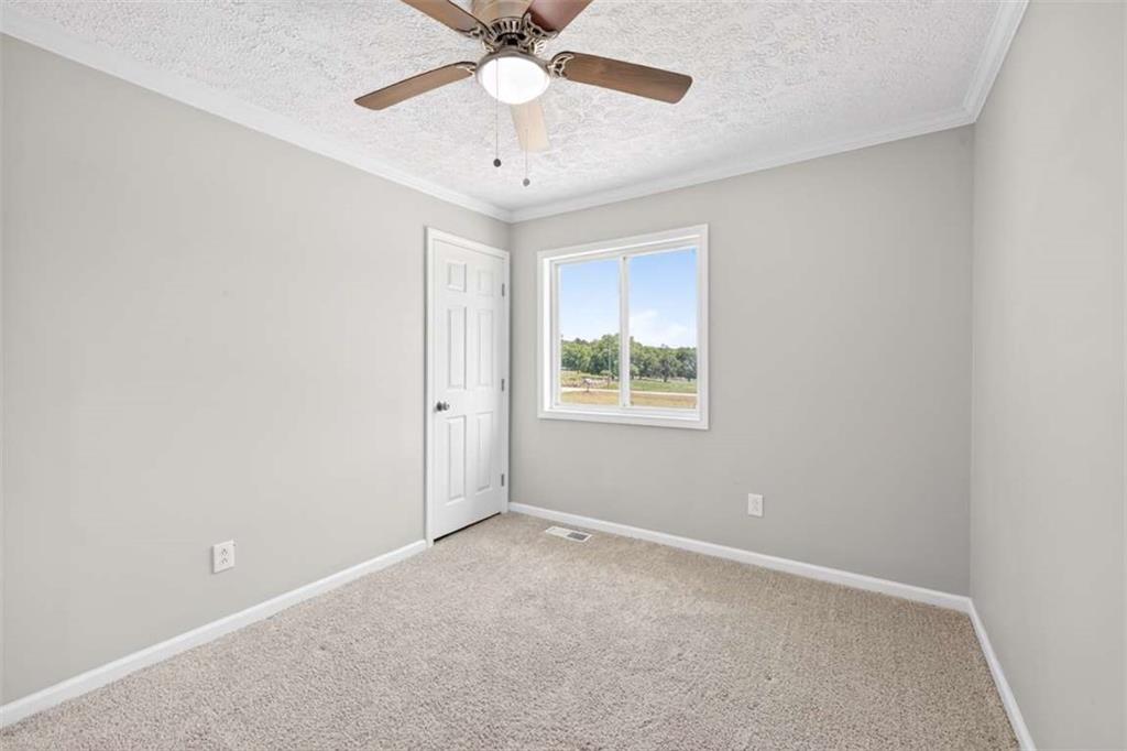 3696 Crabapple Hollow Road Nicholson, GA 30565 - Photo 17 of 38 an empty room with a window and a fan