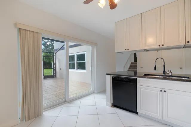 a kitchen with cabinets stainless steel appliances and a sink