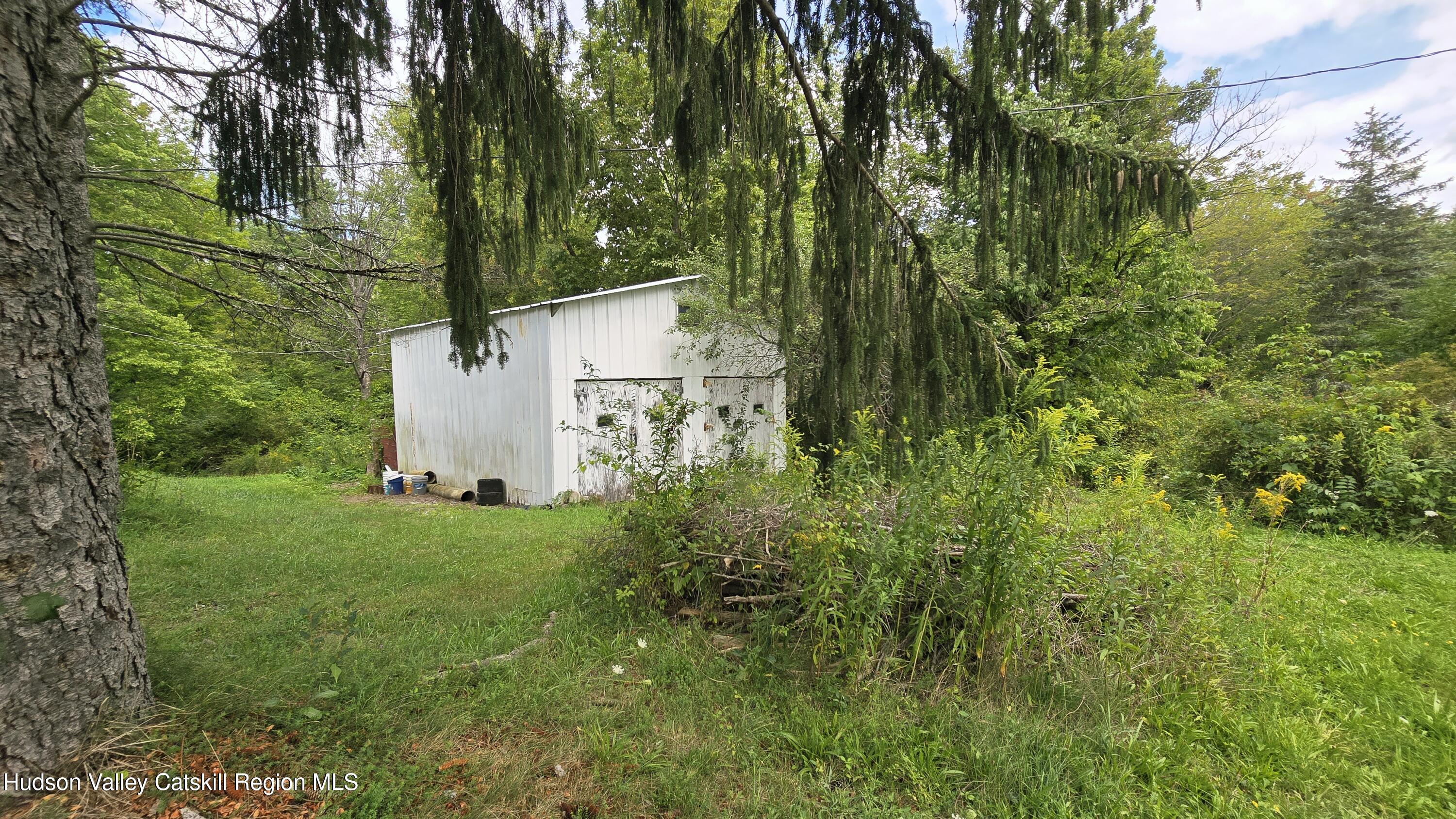 767 Rock City Road Chatham, NY 12136 - Photo 4 of 22 a backyard of a house with lots of green space and a fountain