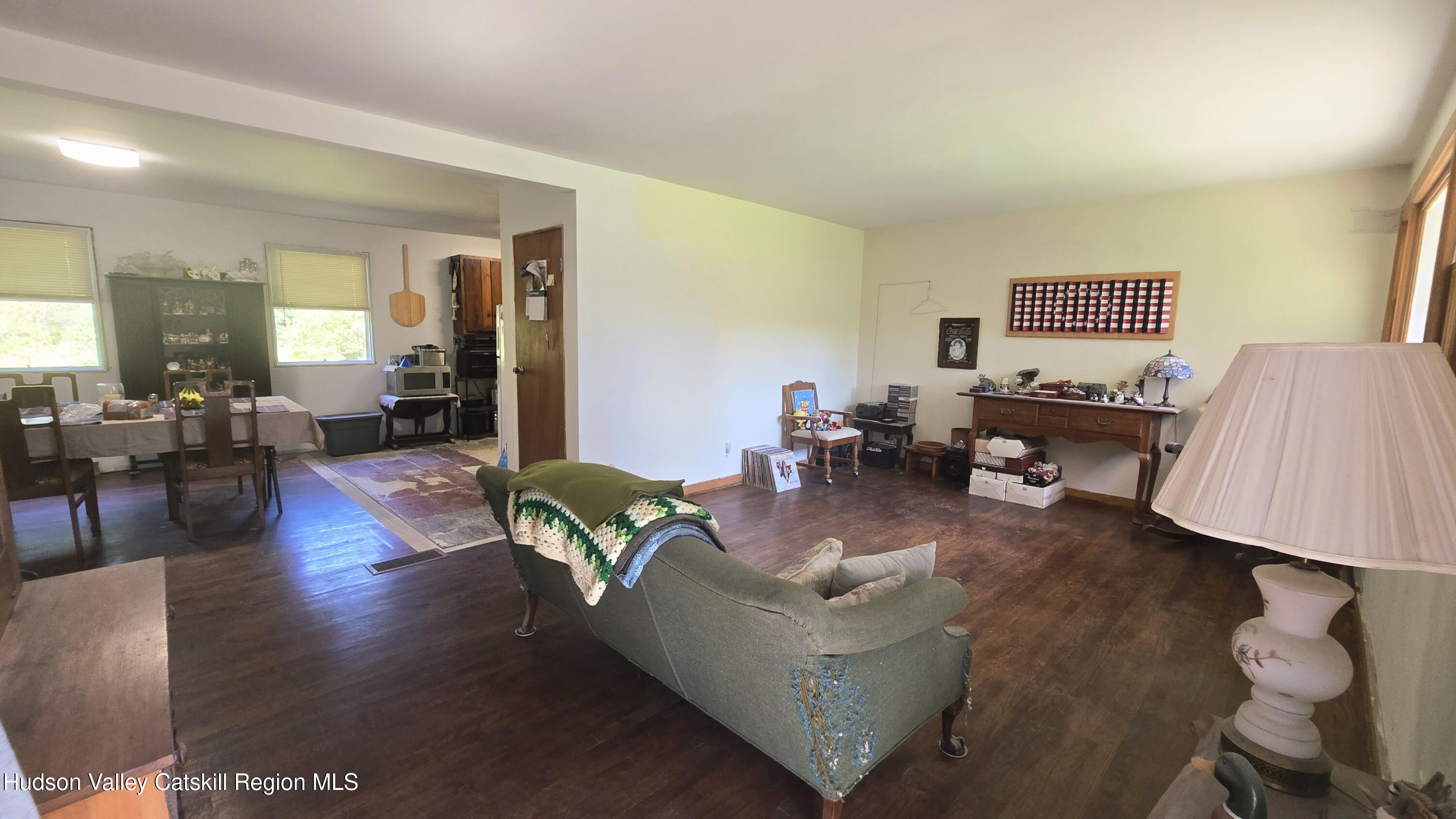 767 Rock City Road Chatham, NY 12136 - Photo 7 of 22 a living room with furniture wooden floor and a lamp