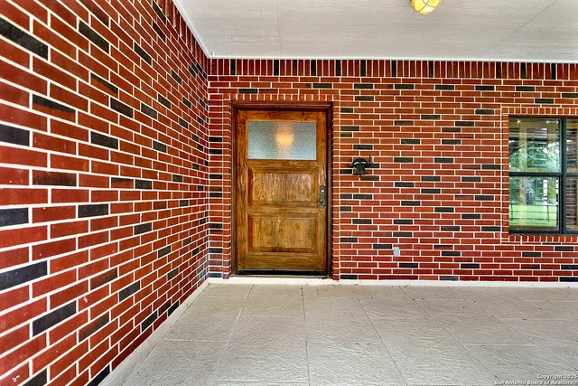 a view of outdoor space with brick walls