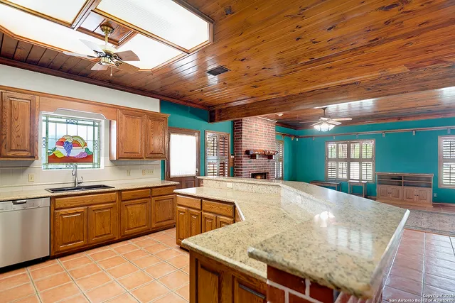 a large kitchen with kitchen island a stove a sink dishwasher and a refrigerator