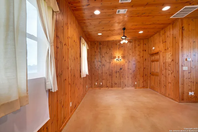 a view of a hallway with chandelier and a window