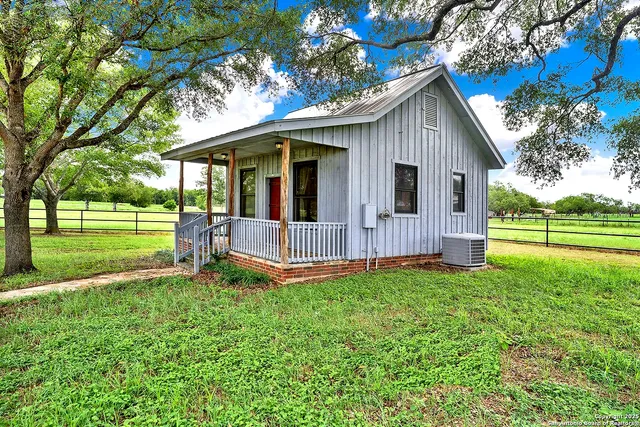 a view of a house with a yard and sitting area