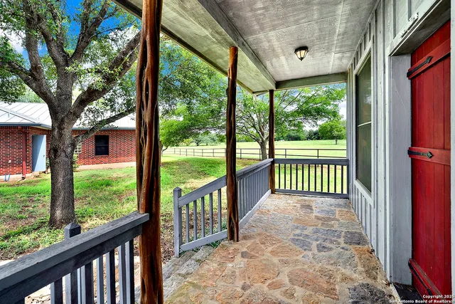 a view of a porch with a large window and front door