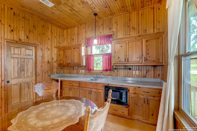 a kitchen with stainless steel appliances granite countertop a sink and cabinets
