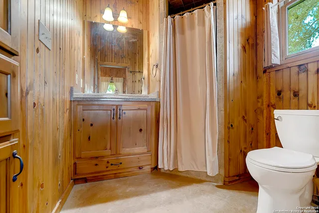 a bathroom with a toilet a sink and shower