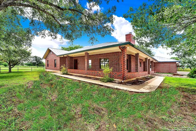 a front view of house with a garden and patio