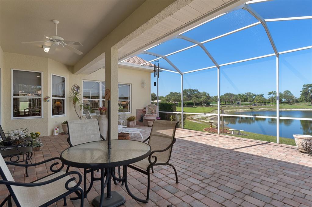 10081 Georgetown Court Weeki Wachee, FL 34613 - Photo 46 of 76 a dining room with furniture and a floor to ceiling window