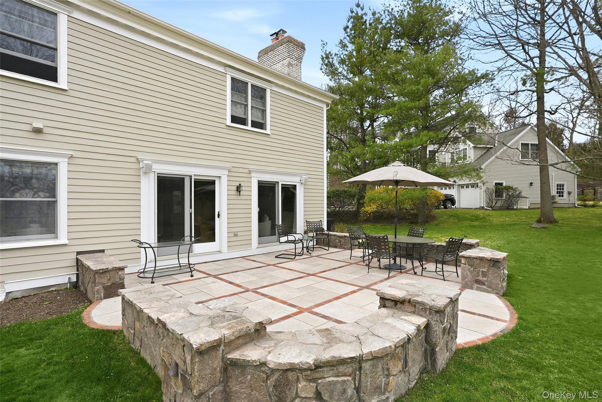 4 Ellis Court Rye, NY 10580 - Photo 27 of 34 Custom designed hardscape with antique brick, limestone inserts and natural stone "sitting" wall