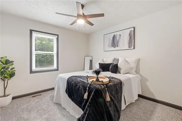 a bedroom with bed and a potted plant
