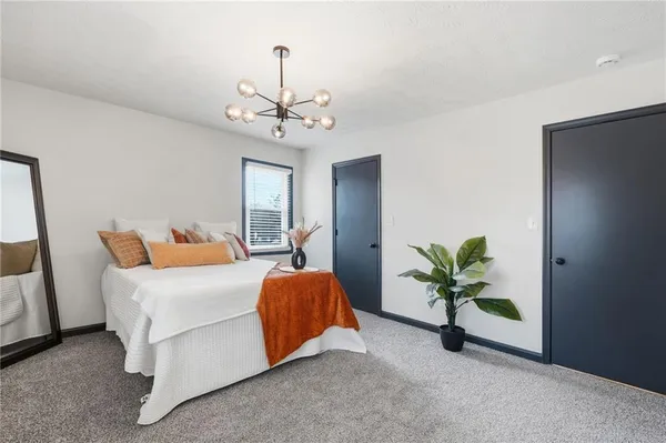 a bed room with a bed and a chandelier