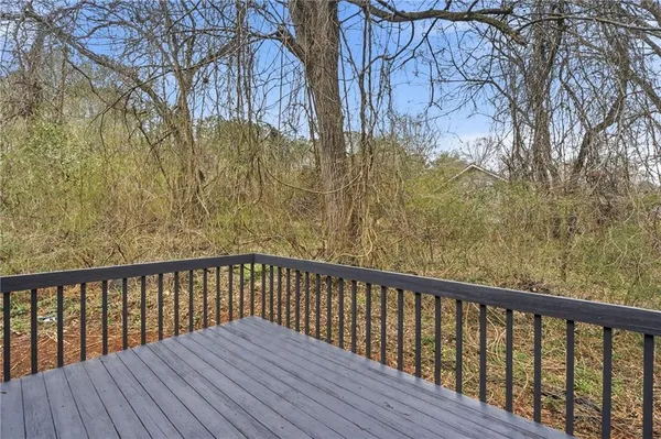 a balcony with wooden floor and fence