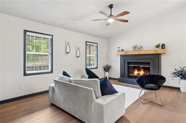 a living room with furniture and a fireplace