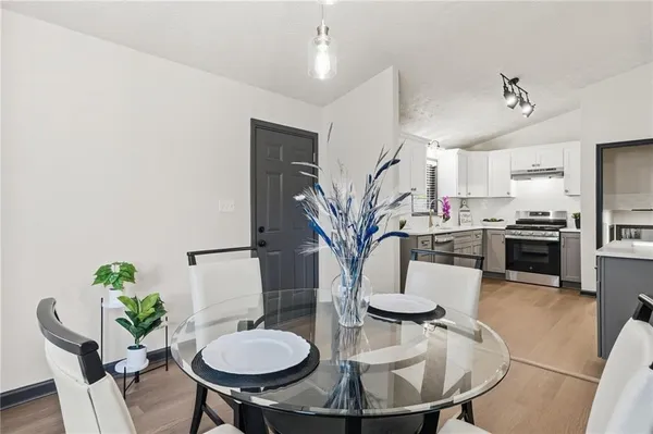 a dining room with furniture and a kitchen