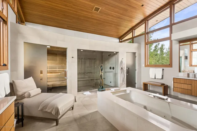 a spacious bedroom with a bed and a large window