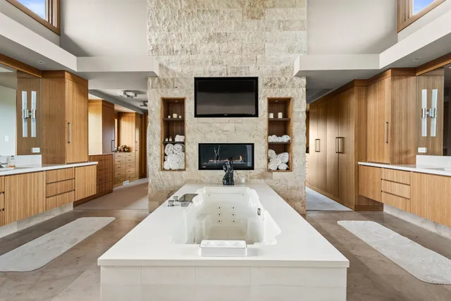a large white kitchen with a large window