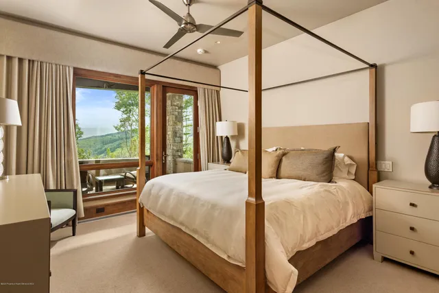 a bedroom with a bed and a large window