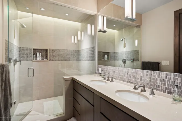 a bathroom with a sink double vanity and a mirror