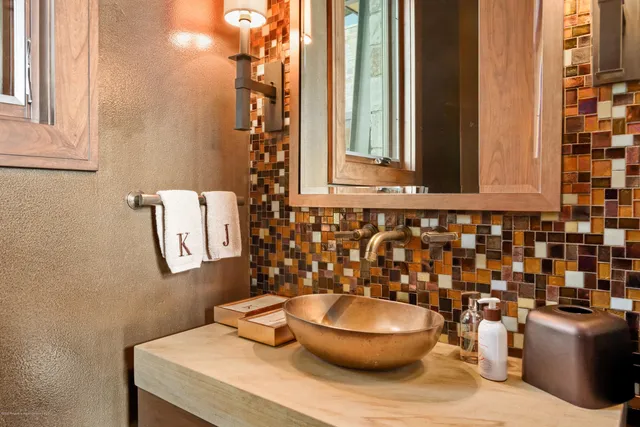 a bathroom with a toilet a sink and a mirror