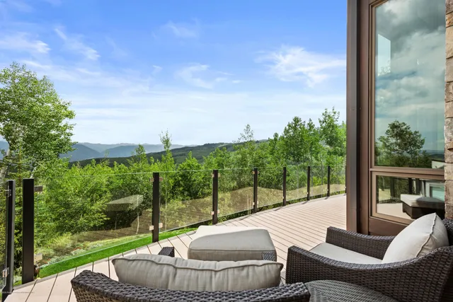 a balcony with furniture and a garden