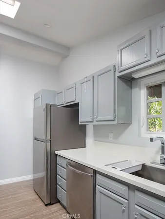 a kitchen with a refrigerator and a sink
