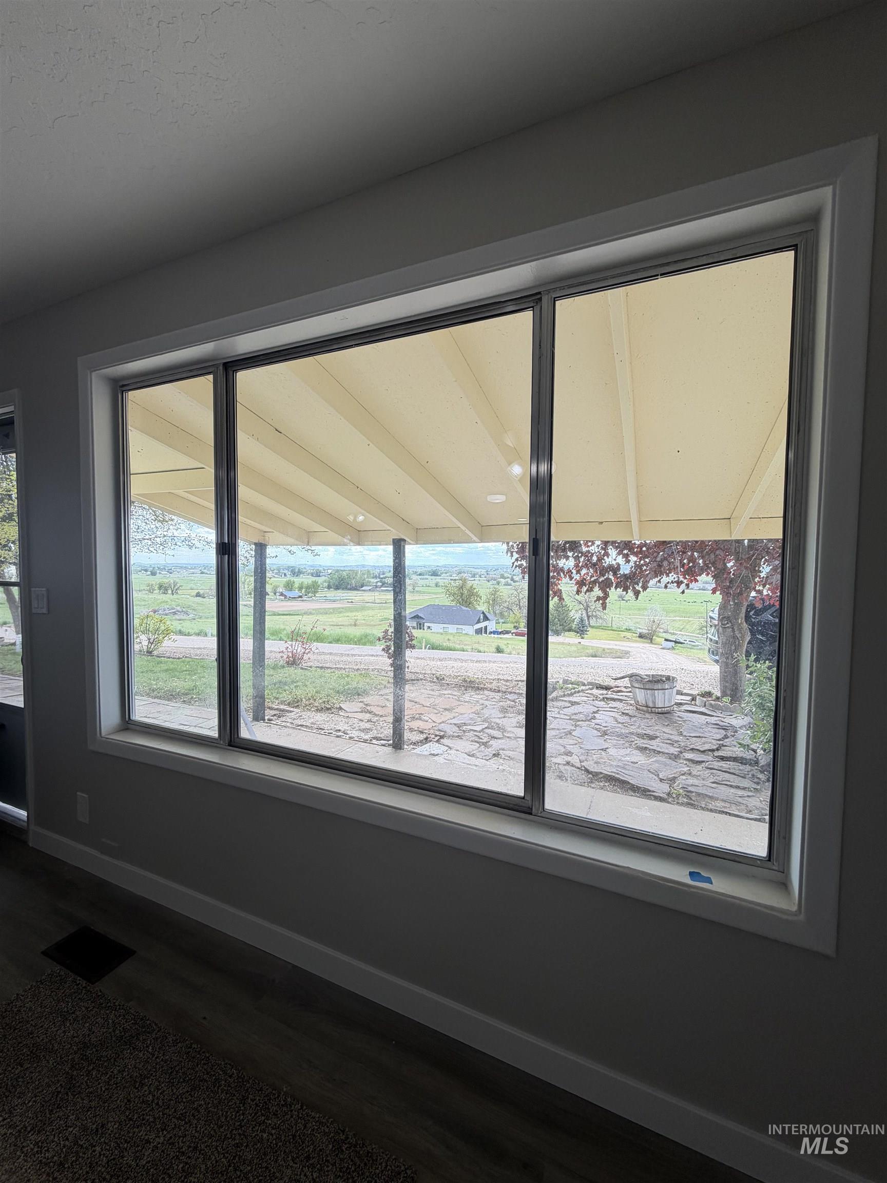 12184 Hill Road Payette, ID 83661 - Photo 12 of 35 Expansive window featuring a white frame and trim, offering panoramic views of the distant landscape