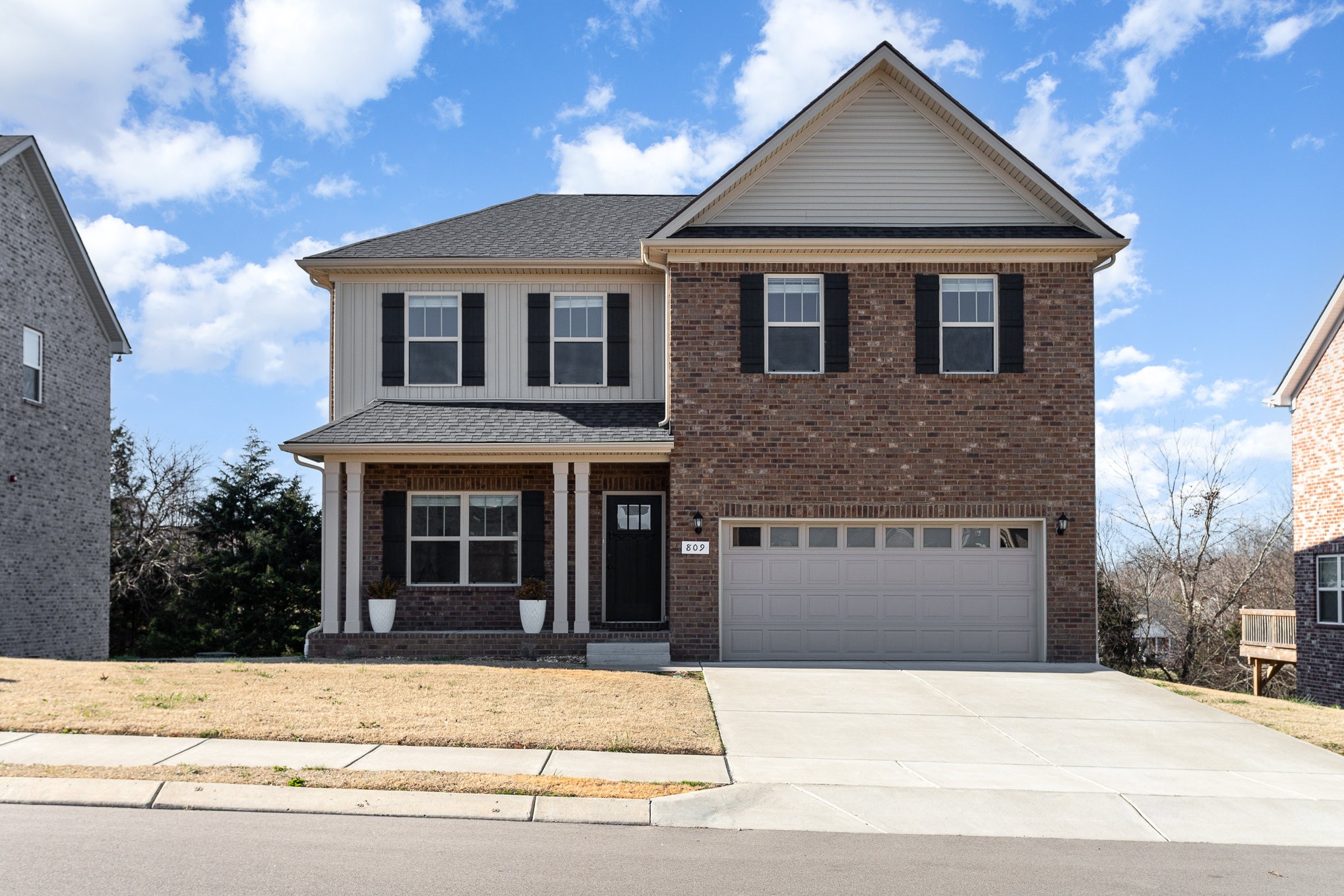 a front view of a house with a garden