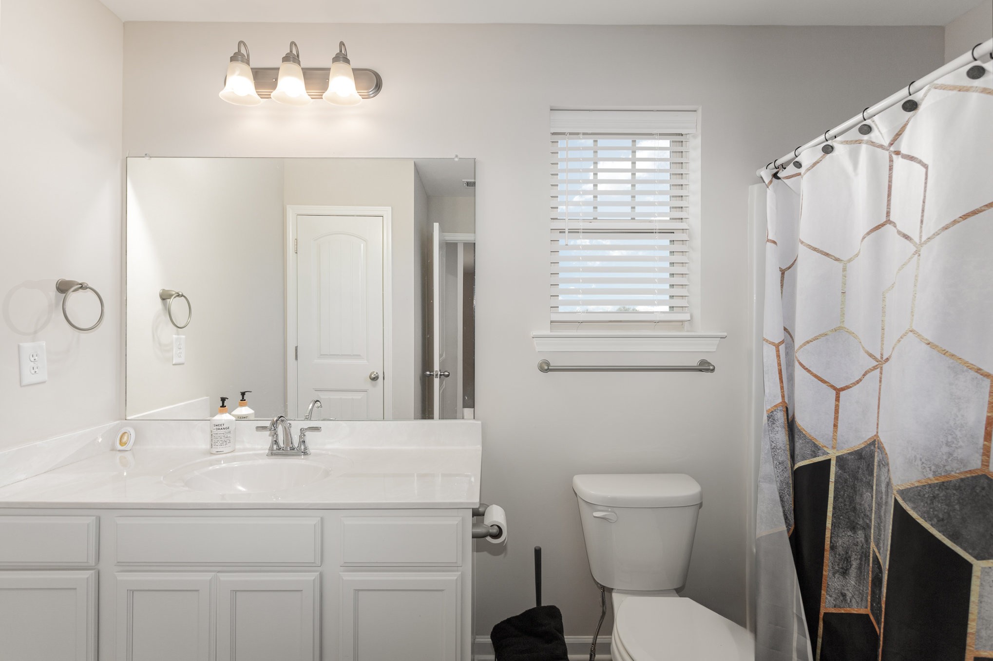 809 Callie Lane Pleasant View, TN 37146 - Photo 27 of 30 a bathroom with a sink vanity mirror and toilet