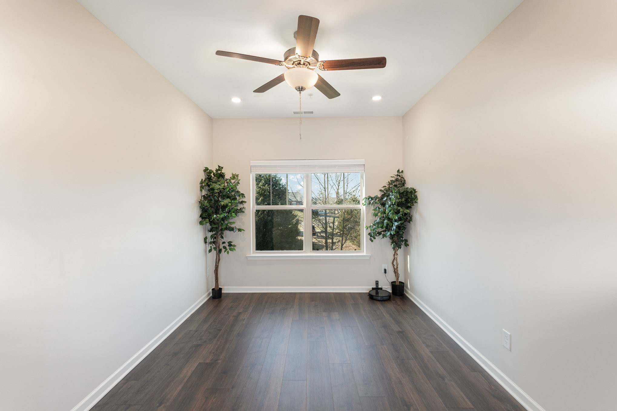 809 Callie Lane Pleasant View, TN 37146 - Photo 10 of 30 an empty room with wooden floor and windows