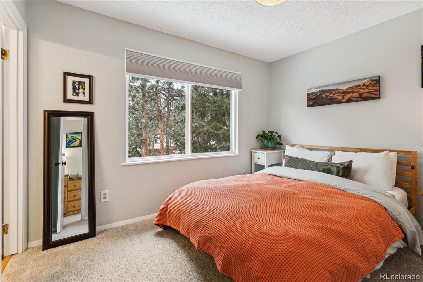 28254 Tresine Drive Evergreen, CO 80439 - Photo 16 of 44 a bed sitting in a bedroom next to a window
