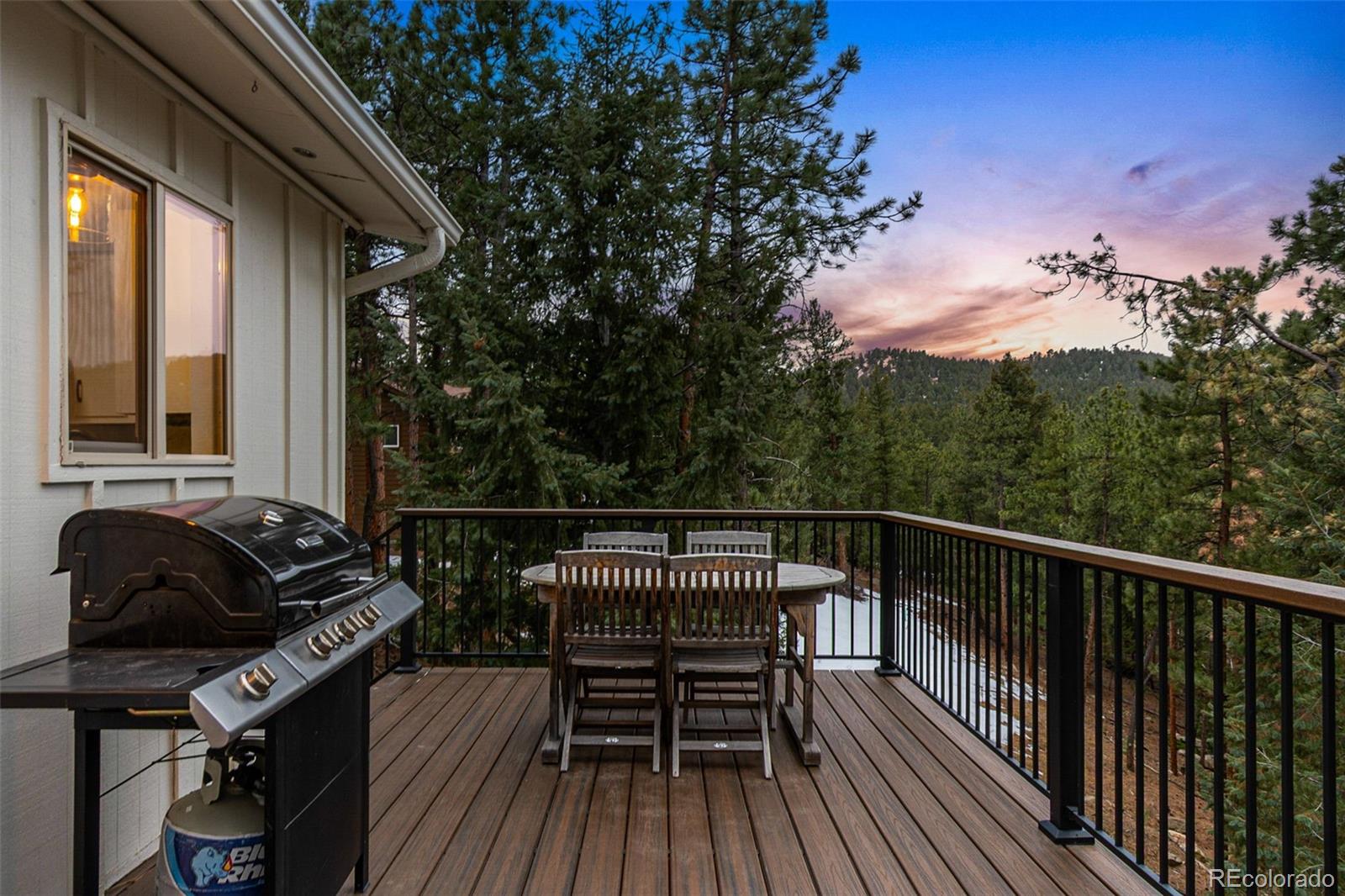 28254 Tresine Drive Evergreen, CO 80439 - Photo 26 of 44 a view of balcony with wooden floor and outdoor seating