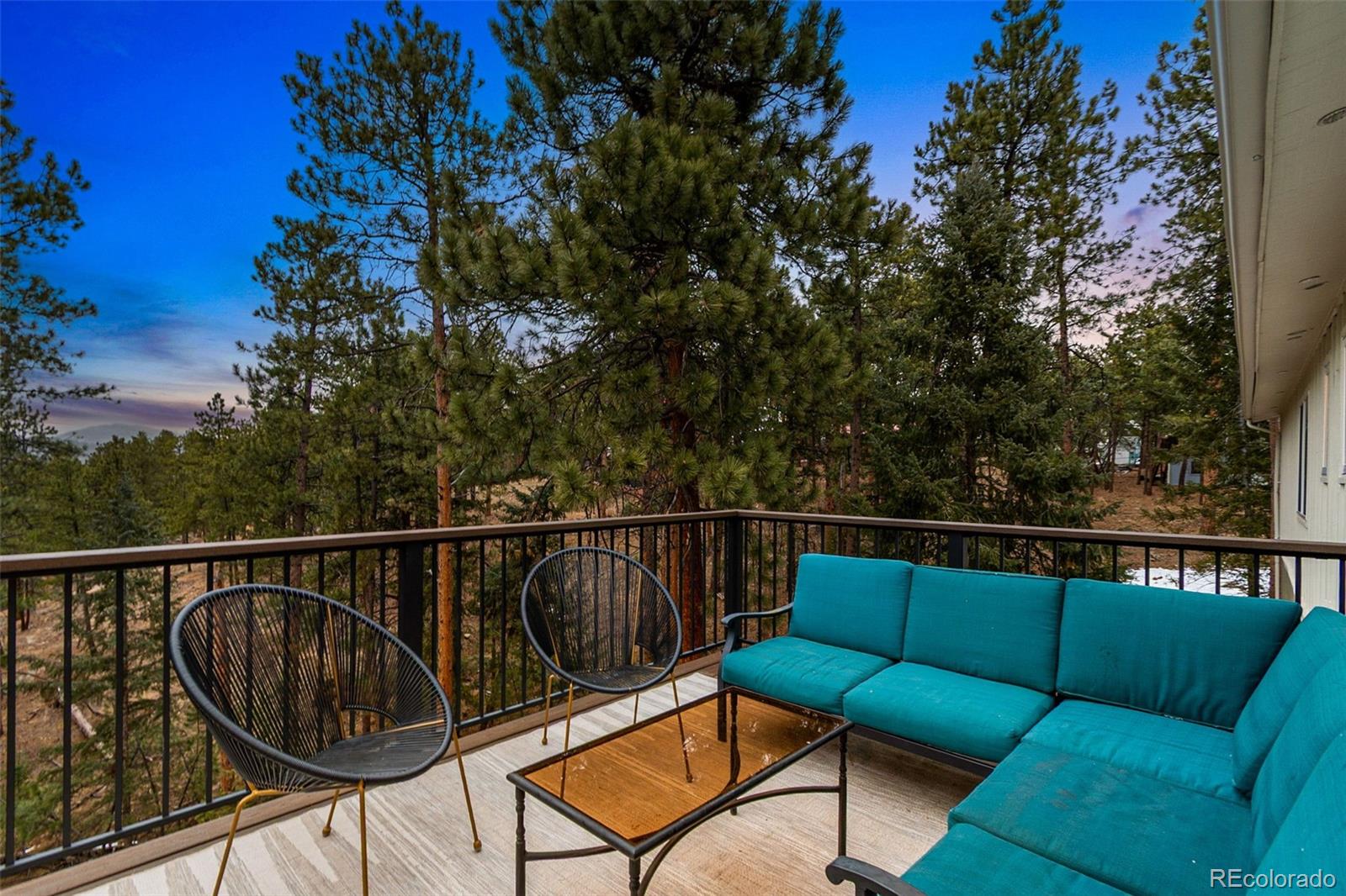 28254 Tresine Drive Evergreen, CO 80439 - Photo 28 of 44 a balcony with furniture and potted plants