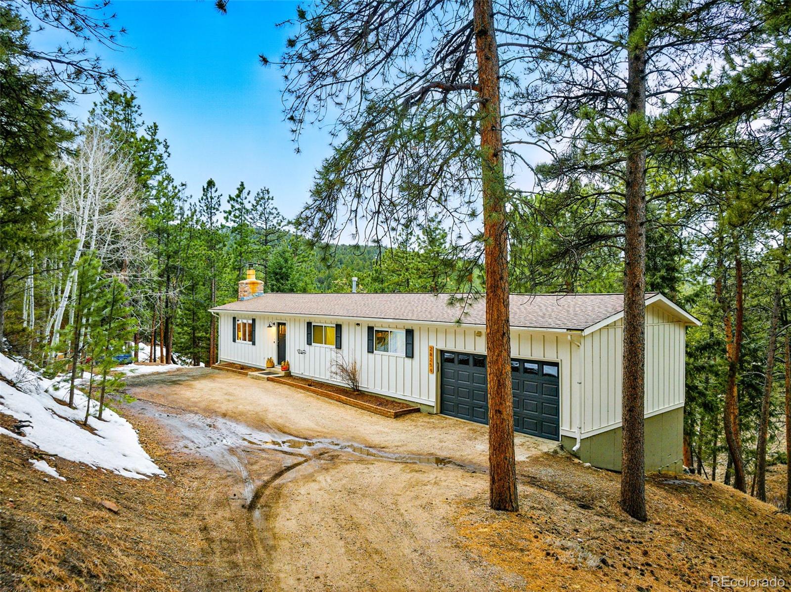 28254 Tresine Drive Evergreen, CO 80439 - Photo 44 of 44 a view of a house with large tree and wooden fence
