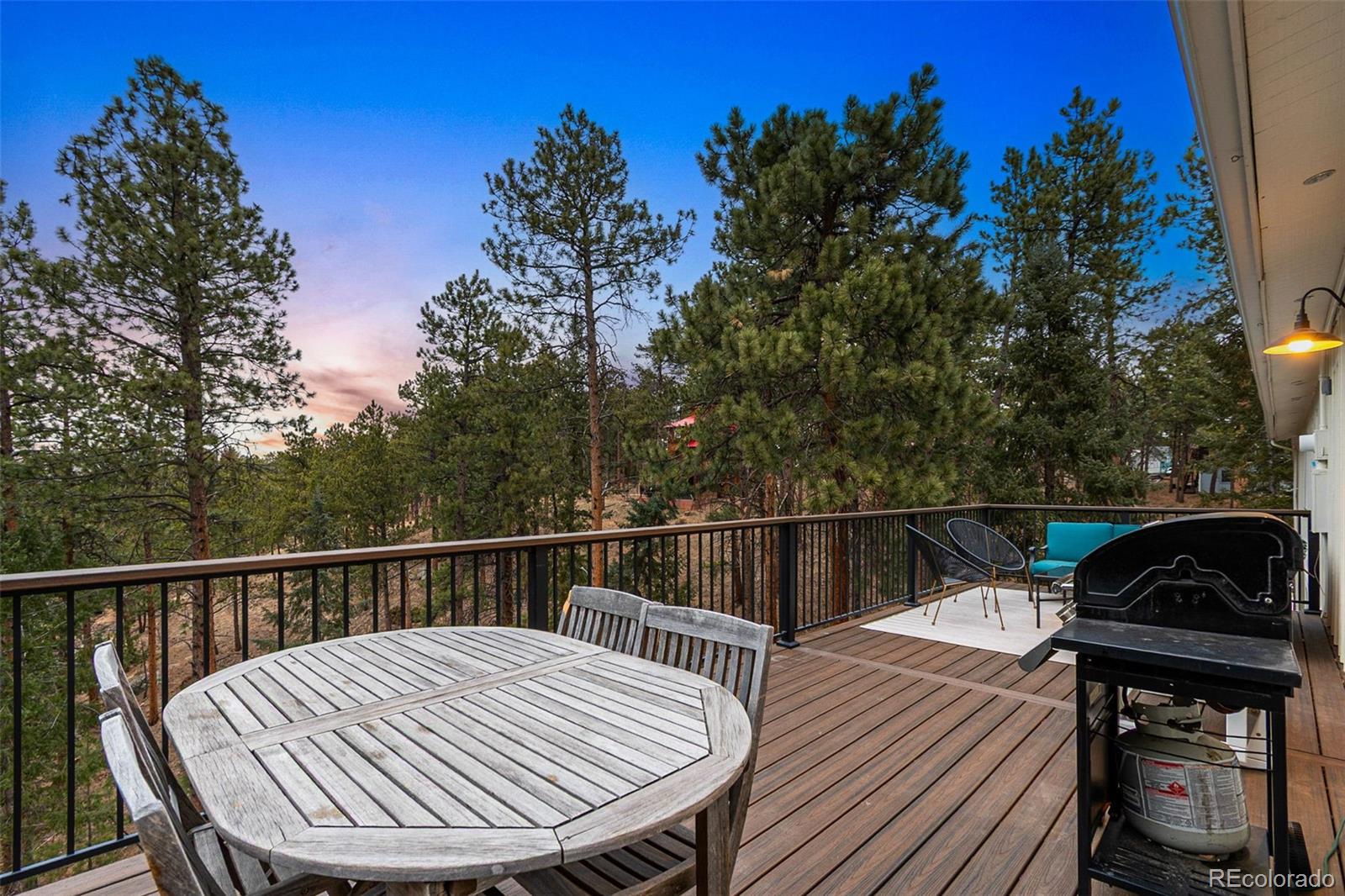 28254 Tresine Drive Evergreen, CO 80439 - Photo 7 of 44 a view of a balcony with two chairs and a potted plant