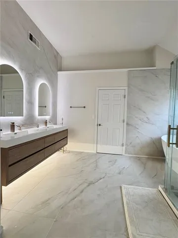 a bathroom with a double vanity sink and a mirror