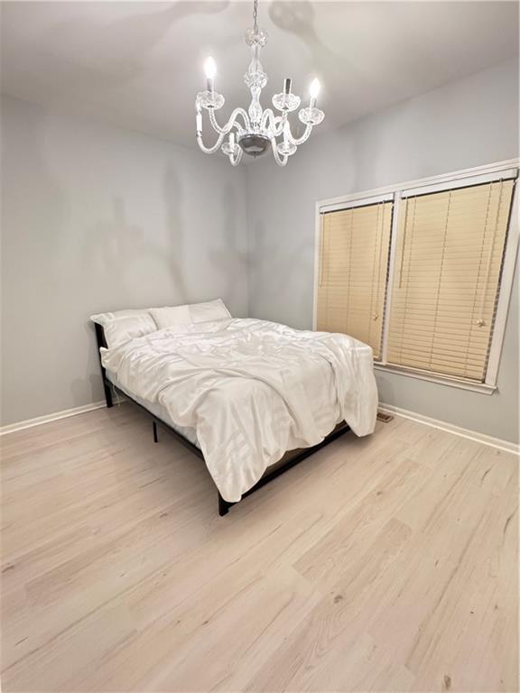 320 Morning Mist Walk Suwanee, GA 30024 - Photo 16 of 19 a bedroom with a large bed and a chandelier