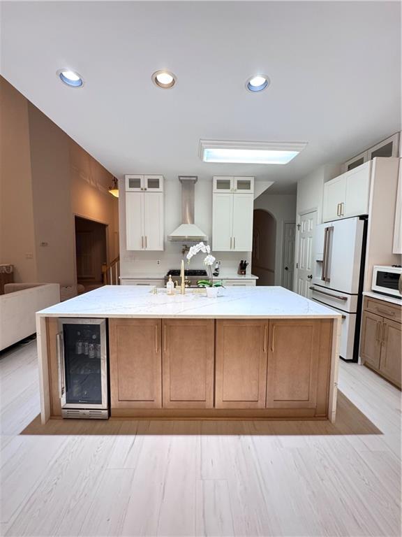 320 Morning Mist Walk Suwanee, GA 30024 - Photo 3 of 19 a living room with stainless steel appliances kitchen island granite countertop a refrigerator a stove a sink dishwasher and white cabinets with wooden floor