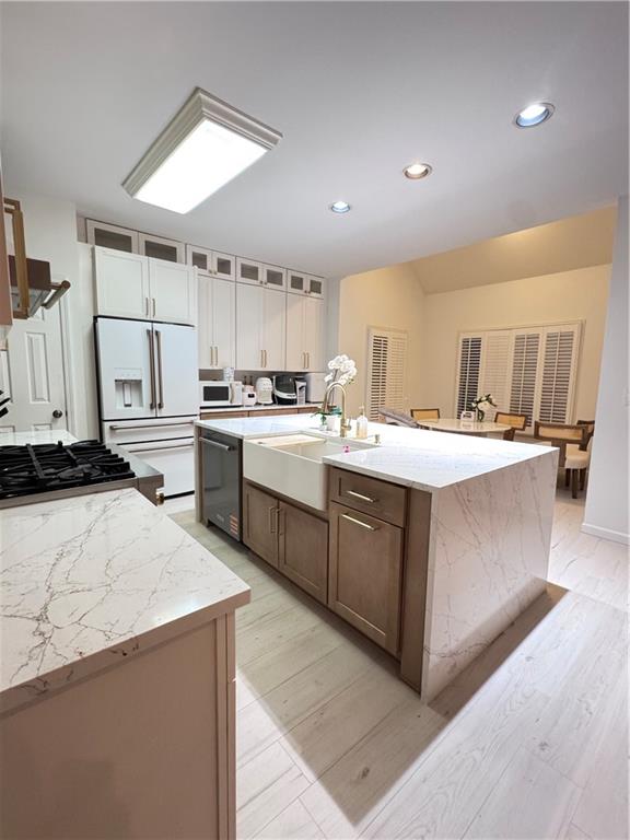 320 Morning Mist Walk Suwanee, GA 30024 - Photo 4 of 19 a kitchen with a sink a stove a refrigerator cabinets and a dining table