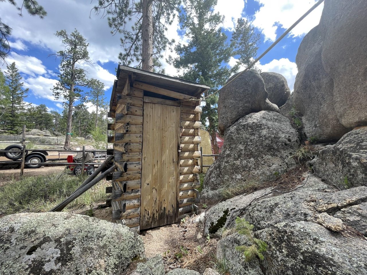 35 Robin Path Red Feather Lakes, CO 80545 - Photo 22 of 25 Outhouse perched among the rocks.
