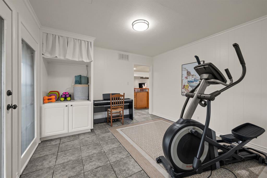10902 Clear Creek Road West Sanger, TX 76266 - Photo 13 of 40 Exercise room with ornamental molding and light tile patterned floors