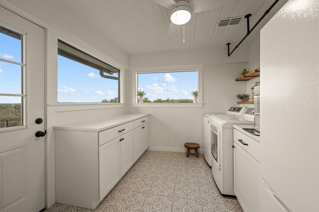 10902 Clear Creek Road West Sanger, TX 76266 - Photo 14 of 40 Laundry area with cabinet space and independent washer and dryer