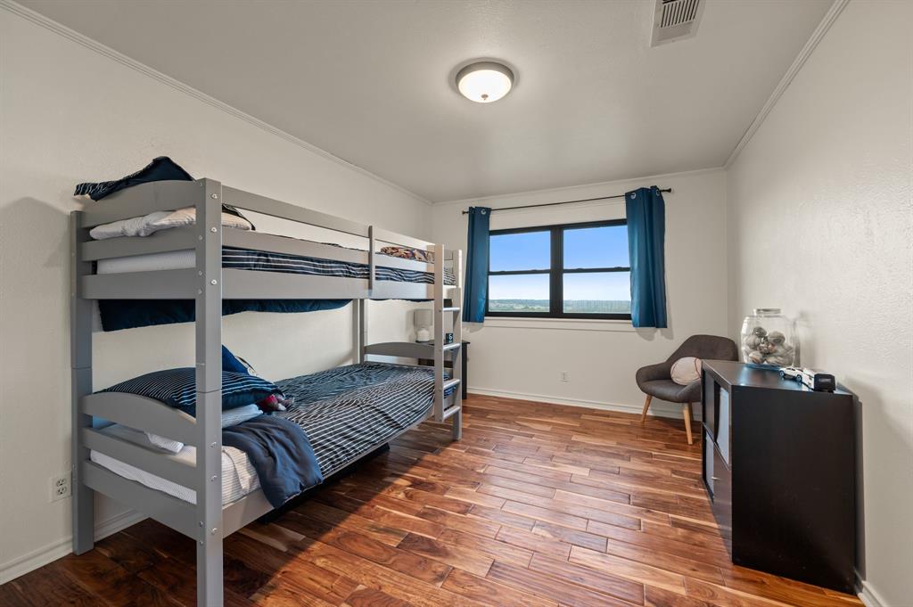 10902 Clear Creek Road West Sanger, TX 76266 - Photo 15 of 40 Bedroom featuring crown molding and wood finished floors