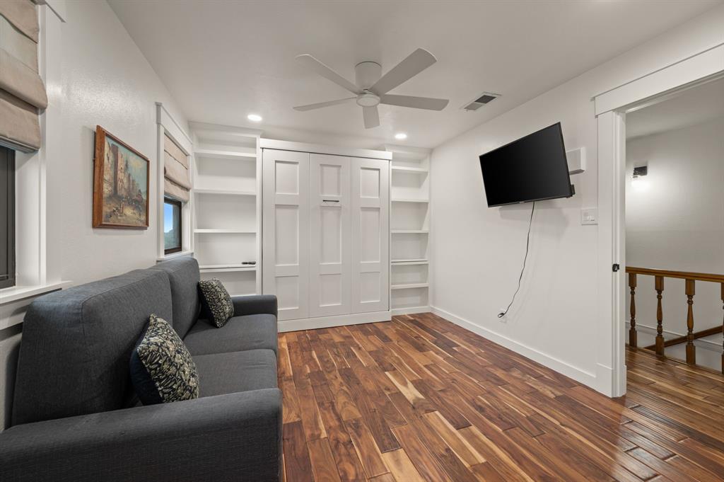 10902 Clear Creek Road West Sanger, TX 76266 - Photo 16 of 40 Living area featuring dark wood-style flooring, built in shelves, recessed lighting, and ceiling fan